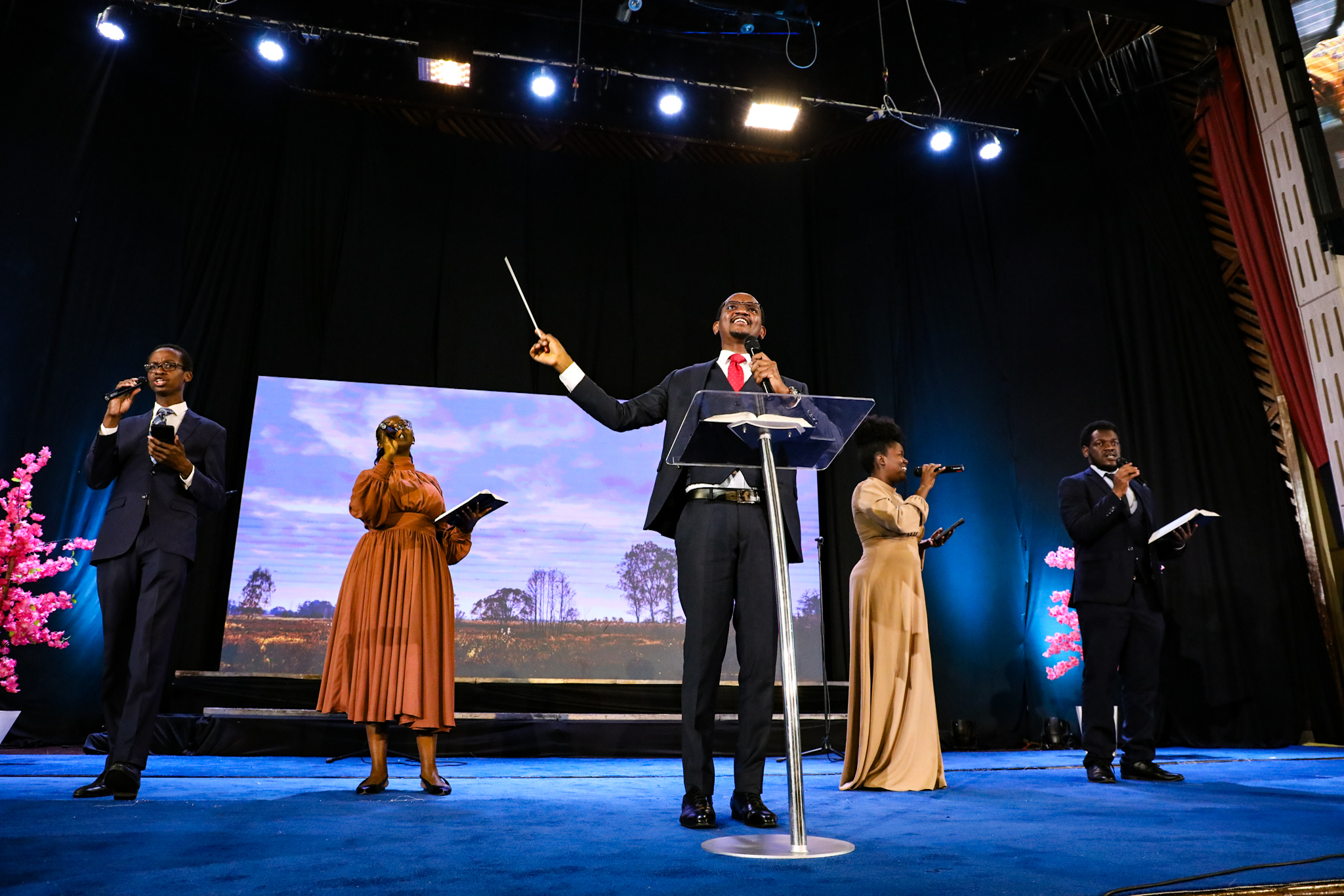 A conductor leading the choir at the Prophesy Again Conference